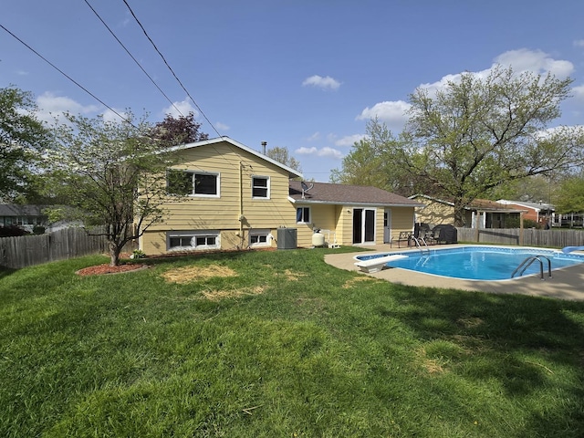 exterior space with a fenced backyard, a fenced in pool, a diving board, and a yard