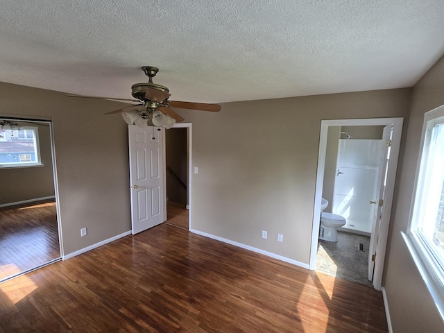 unfurnished bedroom with a textured ceiling, baseboards, ceiling fan, and wood finished floors