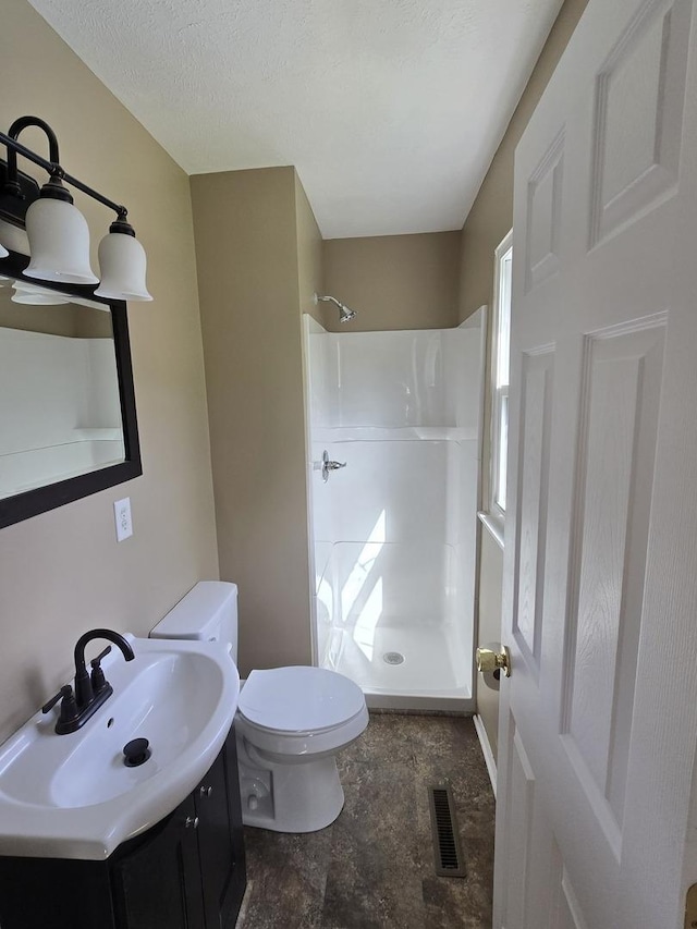 full bath featuring walk in shower, toilet, visible vents, and vanity