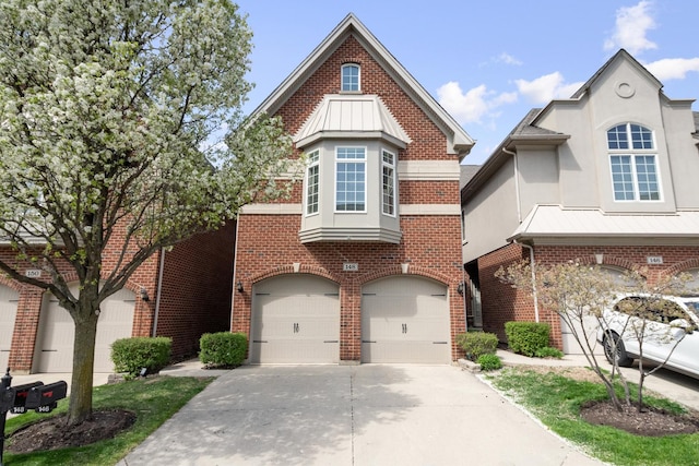 traditional-style house with an attached garage, stucco siding, driveway, and brick siding