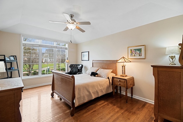 bedroom with baseboards, ceiling fan, and wood finished floors