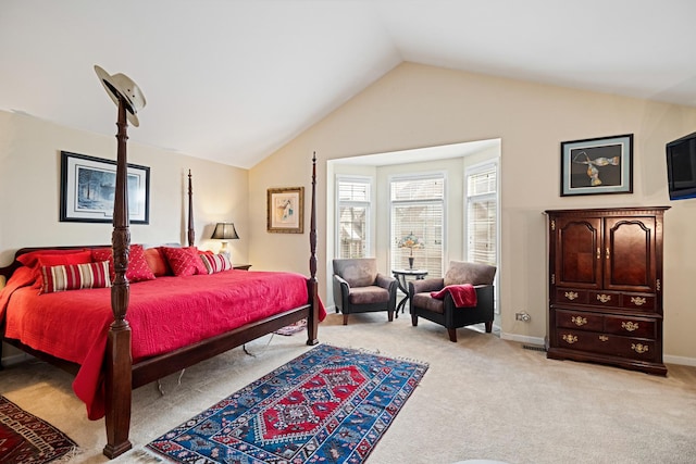 bedroom with baseboards, vaulted ceiling, and light colored carpet
