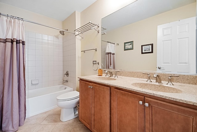 bathroom featuring tile patterned flooring, a sink, double vanity, and toilet