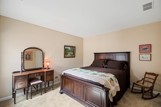 bedroom featuring visible vents, baseboards, and light carpet