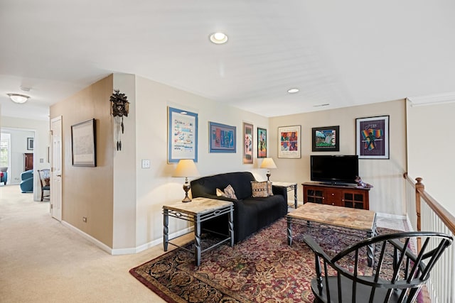 carpeted living area featuring baseboards and recessed lighting