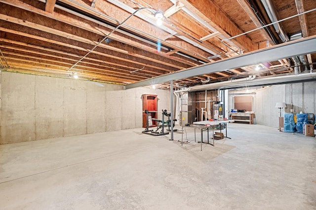 unfinished below grade area featuring water heater
