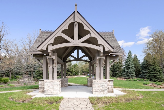 view of property's community with a lawn and a gazebo