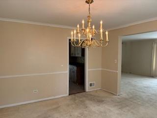 2700 Chariot Ln, Olympia Fields, IL 60461 - unfurnished dining area featuring a chandelier, ornamental molding, and baseboards