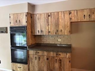 2700 Chariot Ln, Olympia Fields, IL 60461 - kitchen with baseboards, dark countertops, and brown cabinets
