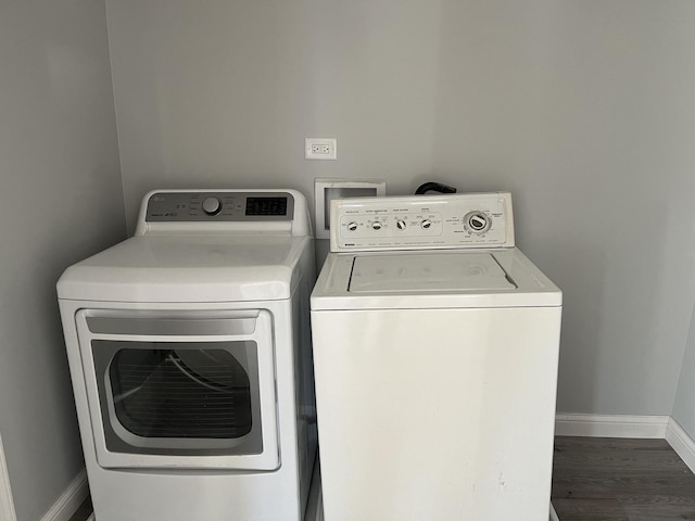 laundry room featuring baseboards, laundry area, independent washer and dryer, and wood finished floors
