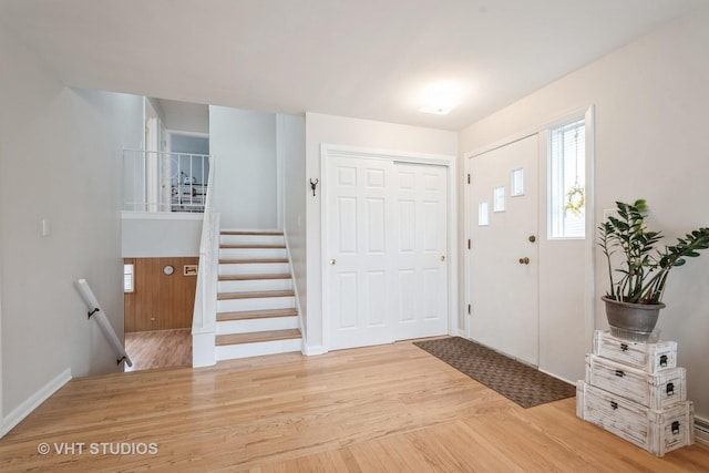 entrance foyer with baseboards and light wood-style flooring