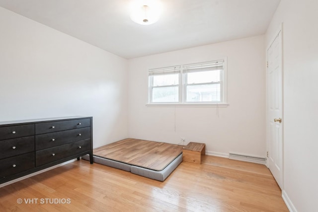 bedroom with baseboards and light wood finished floors