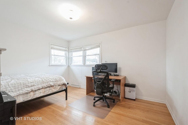 bedroom featuring baseboards and wood finished floors