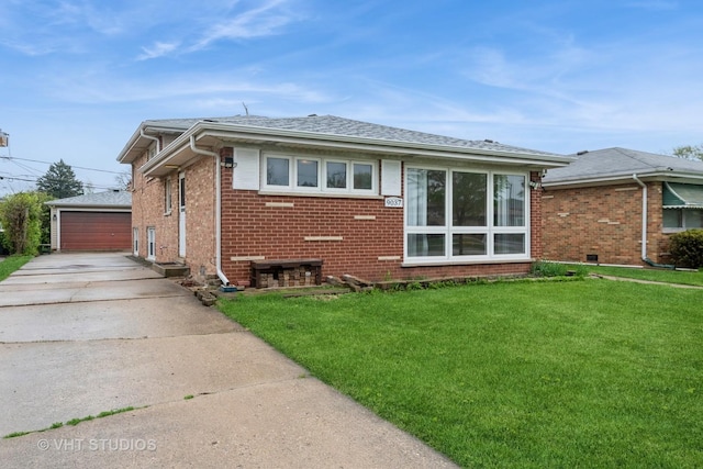 rear view of house featuring a shingled roof, brick siding, a garage, a lawn, and an outdoor structure