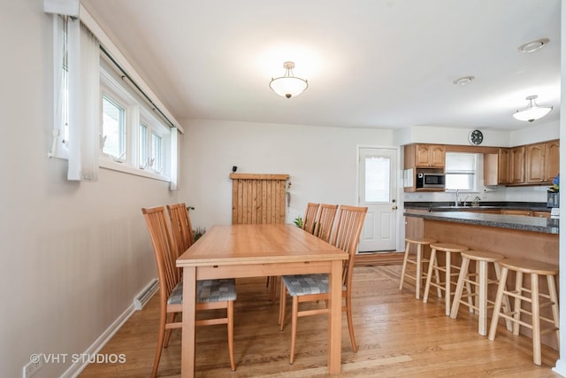 dining area with visible vents, light wood-style flooring, and a healthy amount of sunlight