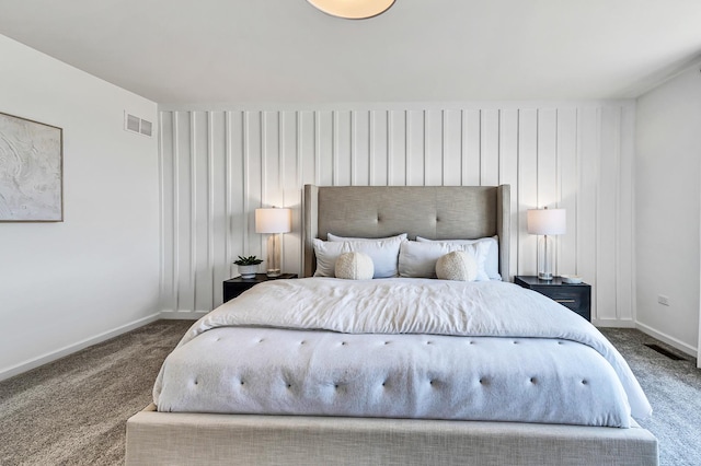 carpeted bedroom featuring baseboards and visible vents