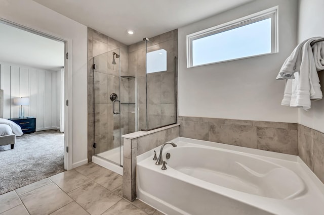 full bathroom featuring a garden tub, ensuite bath, and a stall shower