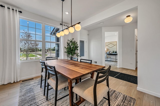 dining room with recessed lighting, baseboards, visible vents, and light wood finished floors