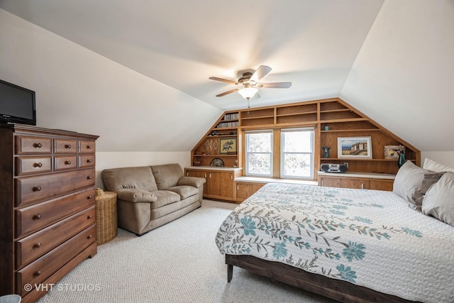 bedroom with ceiling fan, vaulted ceiling, and light carpet