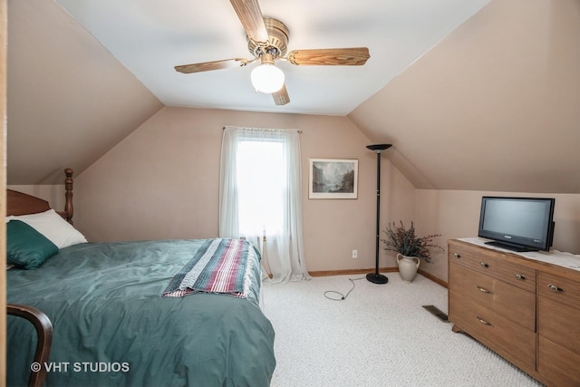 bedroom with ceiling fan, visible vents, vaulted ceiling, baseboards, and light carpet