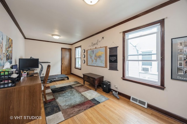 office featuring ornamental molding, light wood-style flooring, and visible vents