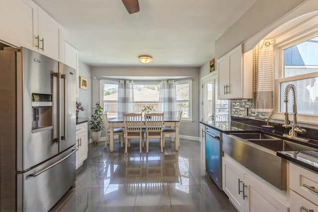 3448 Ann St, Lansing, IL 60438 - kitchen with baseboards, white cabinetry, dark tile patterned flooring, a sink, and appliances with stainless steel finishes