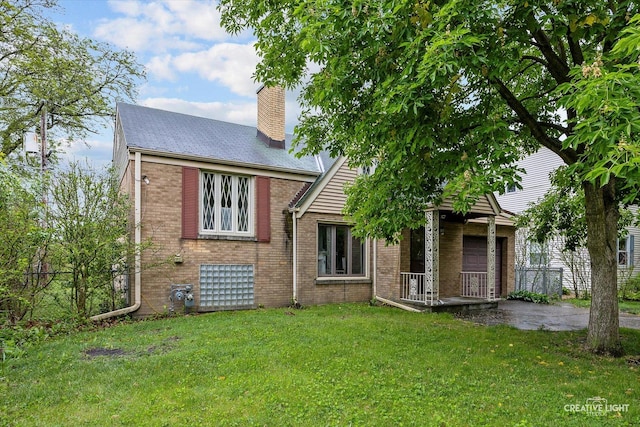 33 Chestnut Ave, Clarendon Hills, IL 60514 - view of front of house with a chimney and brick siding