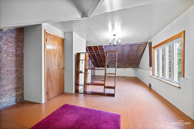 33 Chestnut Ave, Clarendon Hills, IL 60514 - additional living space with a chandelier and wood finished floors