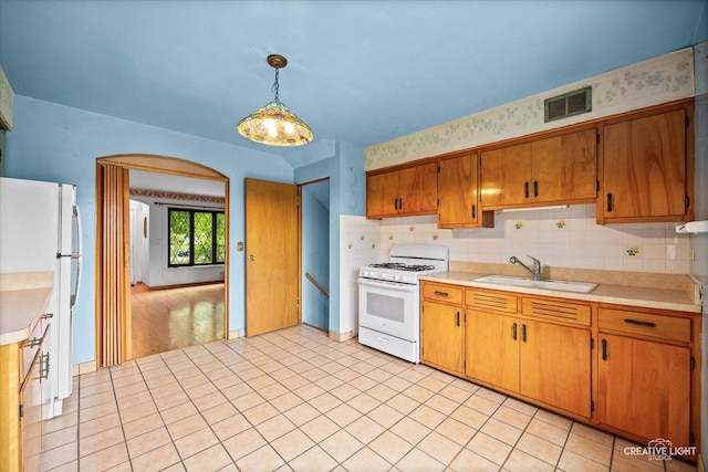 33 Chestnut Ave, Clarendon Hills, IL 60514 - kitchen with white appliances, a sink, light countertops, brown cabinetry, and decorative backsplash