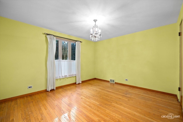 33 Chestnut Ave, Clarendon Hills, IL 60514 - empty room with a chandelier, baseboards, and light wood finished floors
