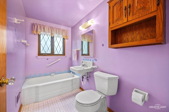33 Chestnut Ave, Clarendon Hills, IL 60514 - bathroom featuring toilet, a tub to relax in, tile patterned floors, baseboards, and lofted ceiling