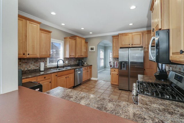 1309 Broad Creek Rd, Bloomington, IL 61704 - kitchen with a healthy amount of sunlight, arched walkways, a sink, appliances with stainless steel finishes, and light tile patterned floors