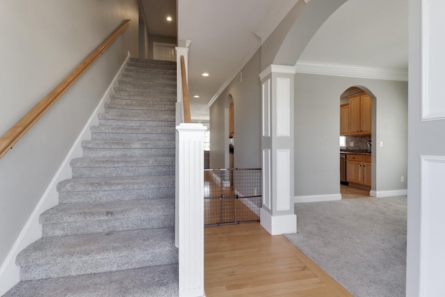 1309 Broad Creek Rd, Bloomington, IL 61704 - staircase with ornamental molding, wood finished floors, carpet flooring, recessed lighting, and arched walkways