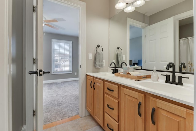 1309 Broad Creek Rd, Bloomington, IL 61704 - bathroom with baseboards, double vanity, ceiling fan, and a sink
