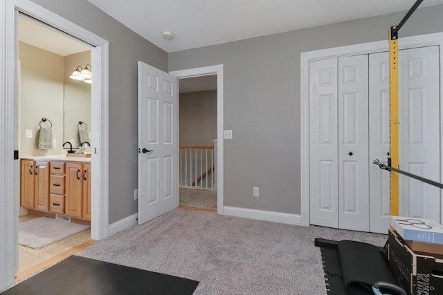 1309 Broad Creek Rd, Bloomington, IL 61704 - exercise room featuring baseboards and light carpet