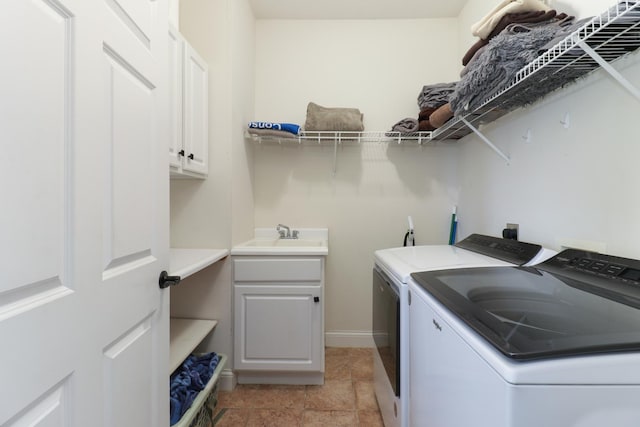 1309 Broad Creek Rd, Bloomington, IL 61704 - laundry area with baseboards, washer and clothes dryer, a sink, and cabinet space