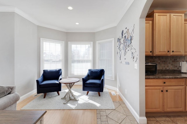 1309 Broad Creek Rd, Bloomington, IL 61704 - sitting room featuring arched walkways, a toaster, baseboards, ornamental molding, and recessed lighting