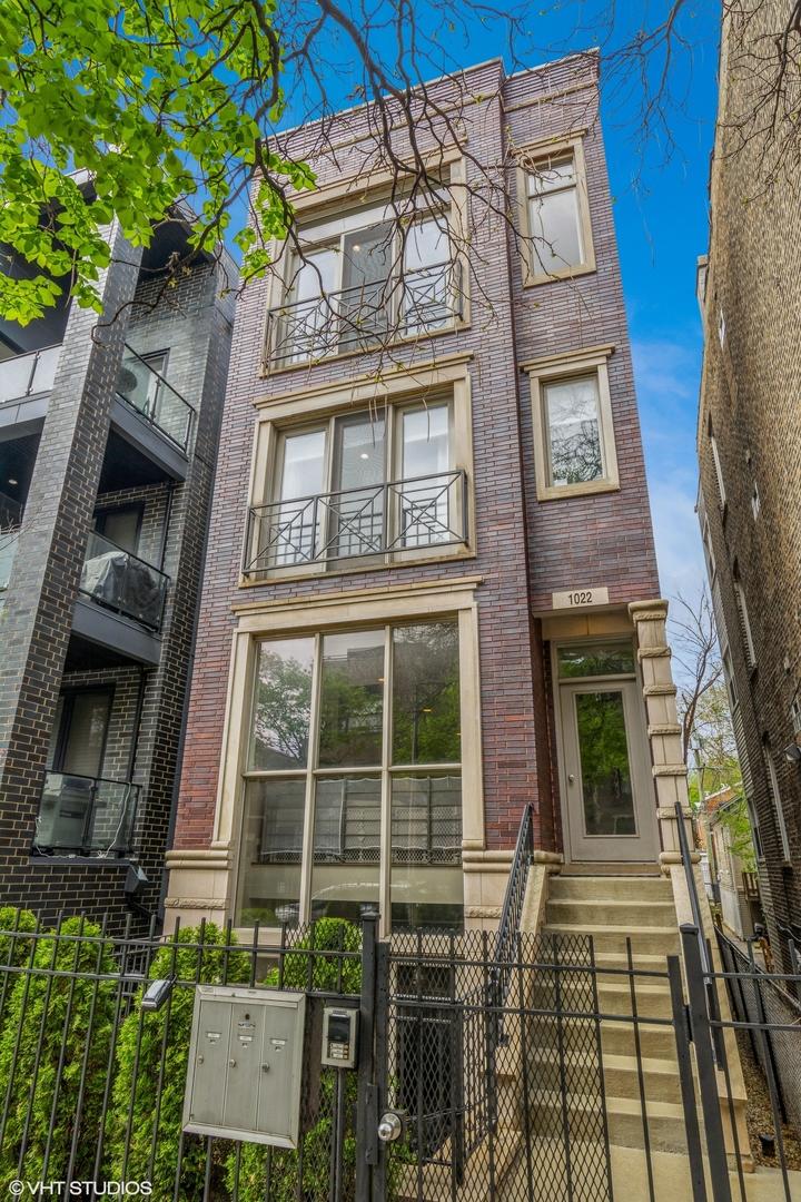 1022 N Marshfield Ave Unit 3, Chicago, IL 60622 - exterior space featuring a fenced front yard and brick siding