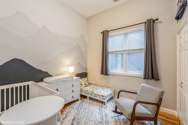 bedroom featuring baseboards and wood finished floors