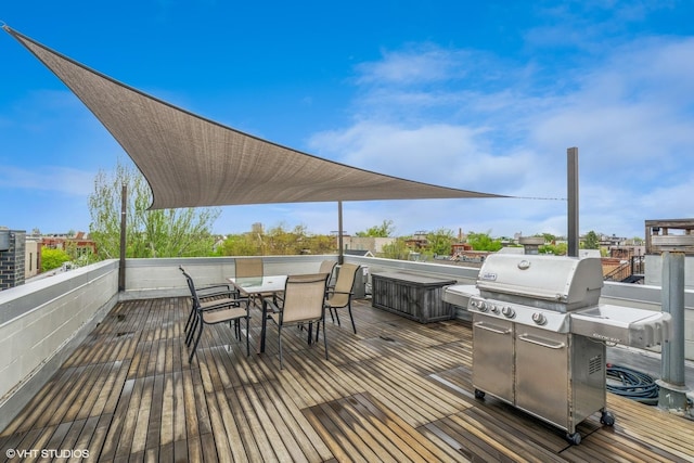 wooden deck featuring area for grilling and outdoor dining space