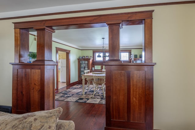 130 N Elm St, Leland, IL 60531 - dining area featuring decorative columns, visible vents, wood finished floors, baseboards, and ornamental molding