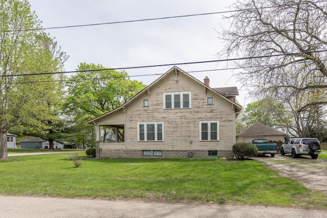 130 N Elm St, Leland, IL 60531 - view of side of property featuring a lawn and a chimney