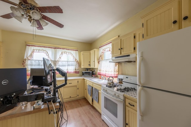 130 N Elm St, Leland, IL 60531 - kitchen featuring white appliances, under cabinet range hood, plenty of natural light, and cream cabinets