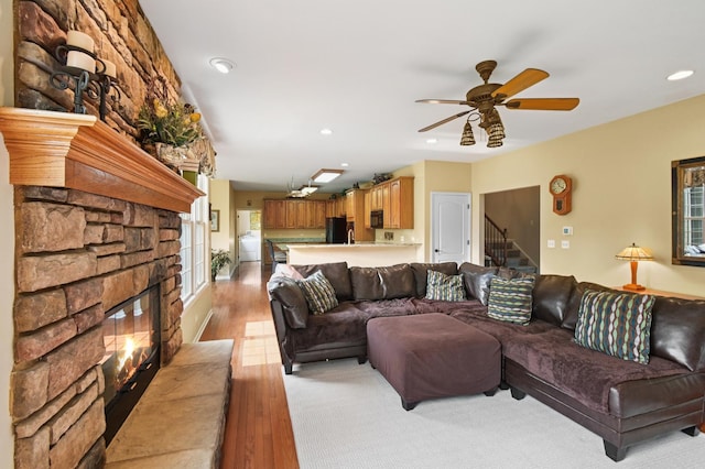 7770 Farrell Dr, Lakewood, IL 60014 - living room featuring a ceiling fan, a stone fireplace, stairway, plenty of natural light, and recessed lighting