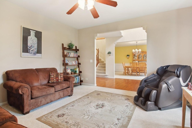 7770 Farrell Dr, Lakewood, IL 60014 - living room featuring ceiling fan, stairway, carpet, and a chandelier