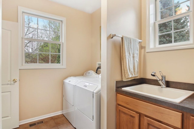 7770 Farrell Dr, Lakewood, IL 60014 - laundry room featuring independent washer and dryer, cabinet space, and tile patterned floors