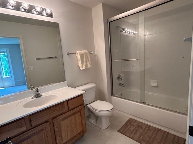 7770 Farrell Dr, Lakewood, IL 60014 - bathroom with vanity, tile patterned flooring, and enclosed tub / shower combo