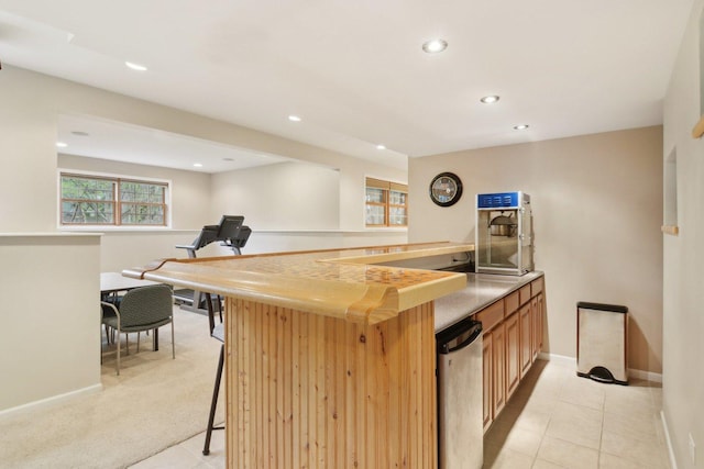 7770 Farrell Dr, Lakewood, IL 60014 - kitchen featuring recessed lighting, light tile patterned flooring, light countertops, and a breakfast bar area