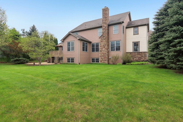 7770 Farrell Dr, Lakewood, IL 60014 - back of property featuring a yard, a chimney, and a deck