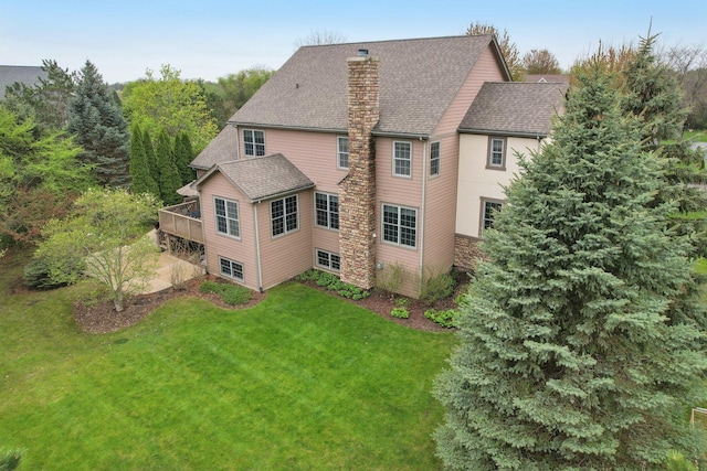 7770 Farrell Dr, Lakewood, IL 60014 - back of property with a chimney, a yard, a shingled roof, and a deck